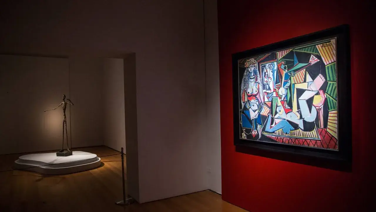 A museum gallery showcases Picasso's "Les Femmes d'Alger" alongside a slender bronze sculpture.