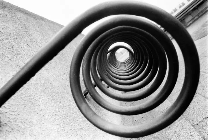 A spiral staircase, reminiscent of Edward Weston's famous photos, draws the eye inward.